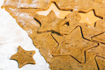 Preparing Christmas gingerbread cookies. Gingerbread dough and star shape cookies ingredients.