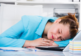 Female employee is sleeping after productive day at work