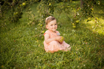 small girl playing in apple orchard