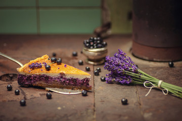 Obraz na płótnie Canvas blueberries and lavander cheesecake served on oven with berries and flowers, still life for patisserie, healthy cake