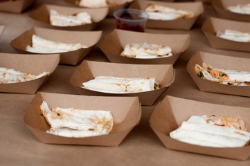 Snacks in paper eco-friendly boxes. Takeout food in a paper box. Fast food on the street