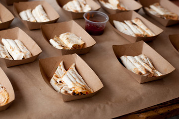 Snacks in paper eco-friendly boxes. Takeout food in a paper box. Fast food on the street