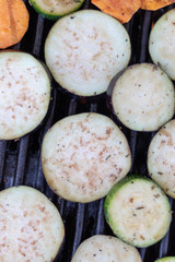 Top view on aubergine slices in the grillage for barbecue