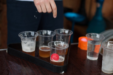 Beer pong game outdoors. Fresh kraft beer in glasses. Top view
