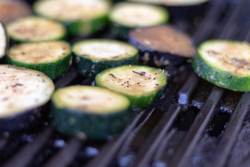 Close up view on courgette slices on the gas grill for barbecue