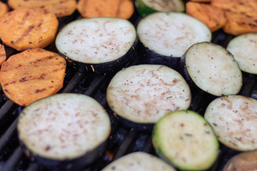 Aubergine, courgette and sweet potatoe slices on the grillage for barbecue