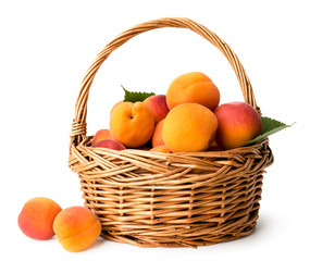 Ripe apricots in a basket on a white, isolated.
