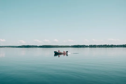 Two Men In A Boat Fishing On A Calm Lake Stock Photo, Picture and Royalty  Free Image. Image 20232002.