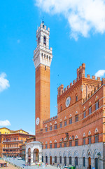 Fototapeta na wymiar Bell tower, Torre del Mangia, of the Town Hall, Palazzo Pubblico, at the Piazza del Campo, Siena, Italy.