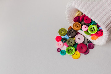  Colorful buttons of different sizes, dropping out of a white texture box. White background, free...