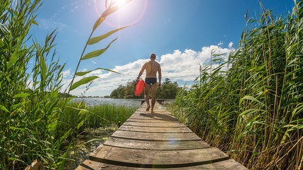 Sexy young man prepares for having an open water swim © DZiegler