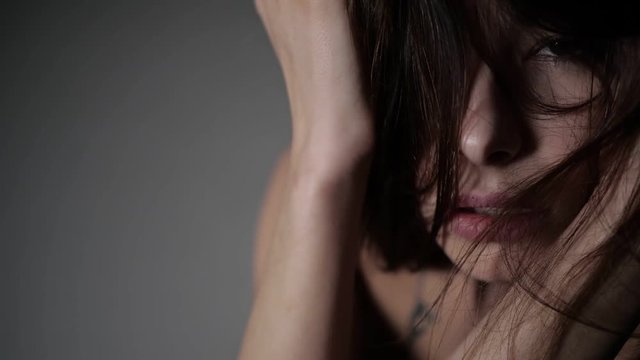 Asian girl is covering her face with hair