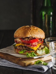 Homemade juicy burger with beef, bacon, cheese and bulgarian pepper. Street food, fast food