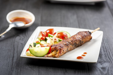 kebab on sticks served with vegetables