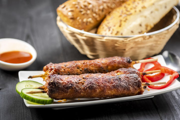 kebab on sticks served with vegetables