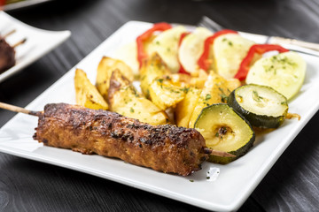 kebab on sticks served with vegetables
