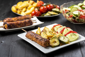 kebab on sticks served with vegetables