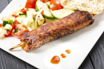 kebab on sticks served with vegetables