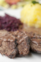 rheinischer Sauerbraten mit Rotkohl auf einem Teller