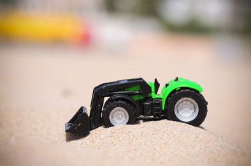 Plastic Toy tractor in the sand