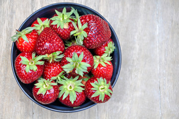 image of red strawberry in wooden background with copy space 