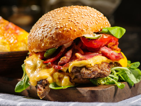 Homemade juicy burger with beef, bacon, cheese and bulgarian pepper. Street food, fast food