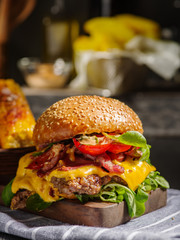 Homemade juicy burger with beef, bacon, cheese and bulgarian pepper. Street food, fast food