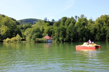 People enjoying beautiful summer day riding a water bike (hydro bicycle). 