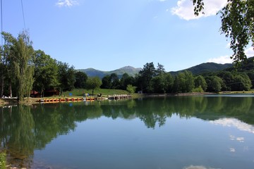 Fototapeta na wymiar Green hill and lake panorama view