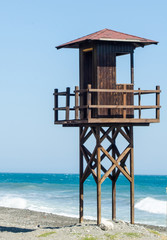 rescue hut on a sandy beach, safe relax by the ocean, a beautiful sunny day
