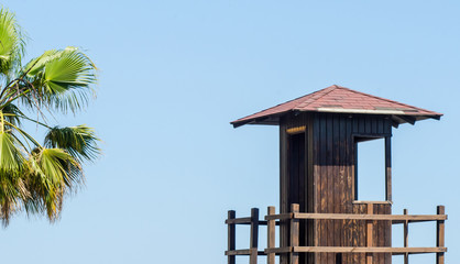 rescue hut on a sandy beach, safe relax by the ocean, a beautiful sunny day