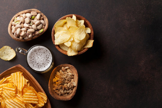 Lager Beer And Snacks On Stone Table