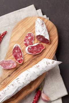 Sliced salami on cutting board