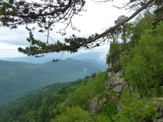 Beautiful dramatic sunset in the mountains. Landscape with sun light shining through orange clouds