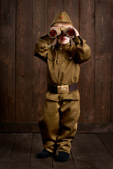 children are dressed as soldier in retro military uniforms