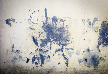 beige wall with torn fragments of paint