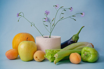 Fruits and toilet paper on a blue background. Natural remedy for constipation. The concept of...