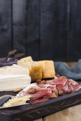 Assorted cheese, meat and olives. A delicious Italian snack for a party. Copy space.