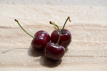 Three cherry on wooden background