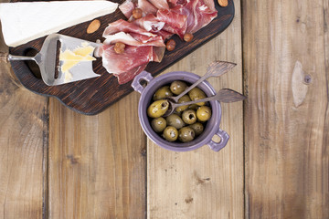 Assorted cheese, meat and olives. A delicious Italian snack for a party. Copy space.