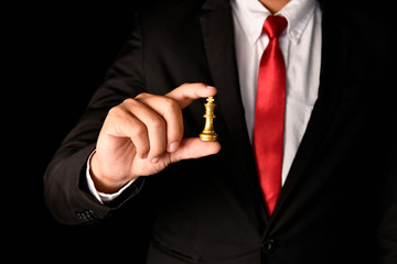 Fototapeta premium Leadership Concepts. Chess is a leader. Comparing chess is a strategic business plan. Chess game on a black background.
