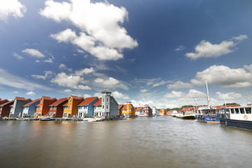 colorful buildings on water and ships  at harbor