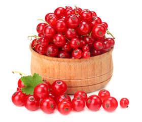 red currant in wooden bowl with green leaf isolated on white background. healthy food