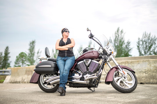 Female Biker or Woman Motorcycle Rider with Arms Crossed