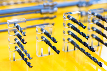 Drill bits(countersinks, twist drills or twist bits) exhibited on yellow background