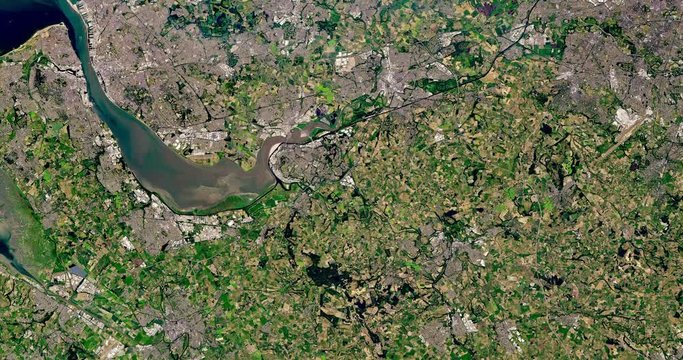 Very high-altitude overflight aerial of Mersey River and adjacent land, Britain. Clip loops and is reversible. Elements of this image furnished by USGS/NASA Landsat