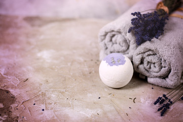 Natural cosmetics. Handmade lavender bath bombs, lavender flowers and towel on white wooden planks, top view