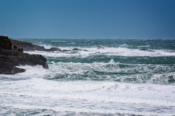 Dramatic stormy sea with large waves crashing onto rocks