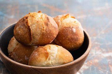 Fresh bread in a black bowl. Copy space. French bread. Fresh rolls.