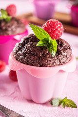 Sweet chocolate cupcake on pink background